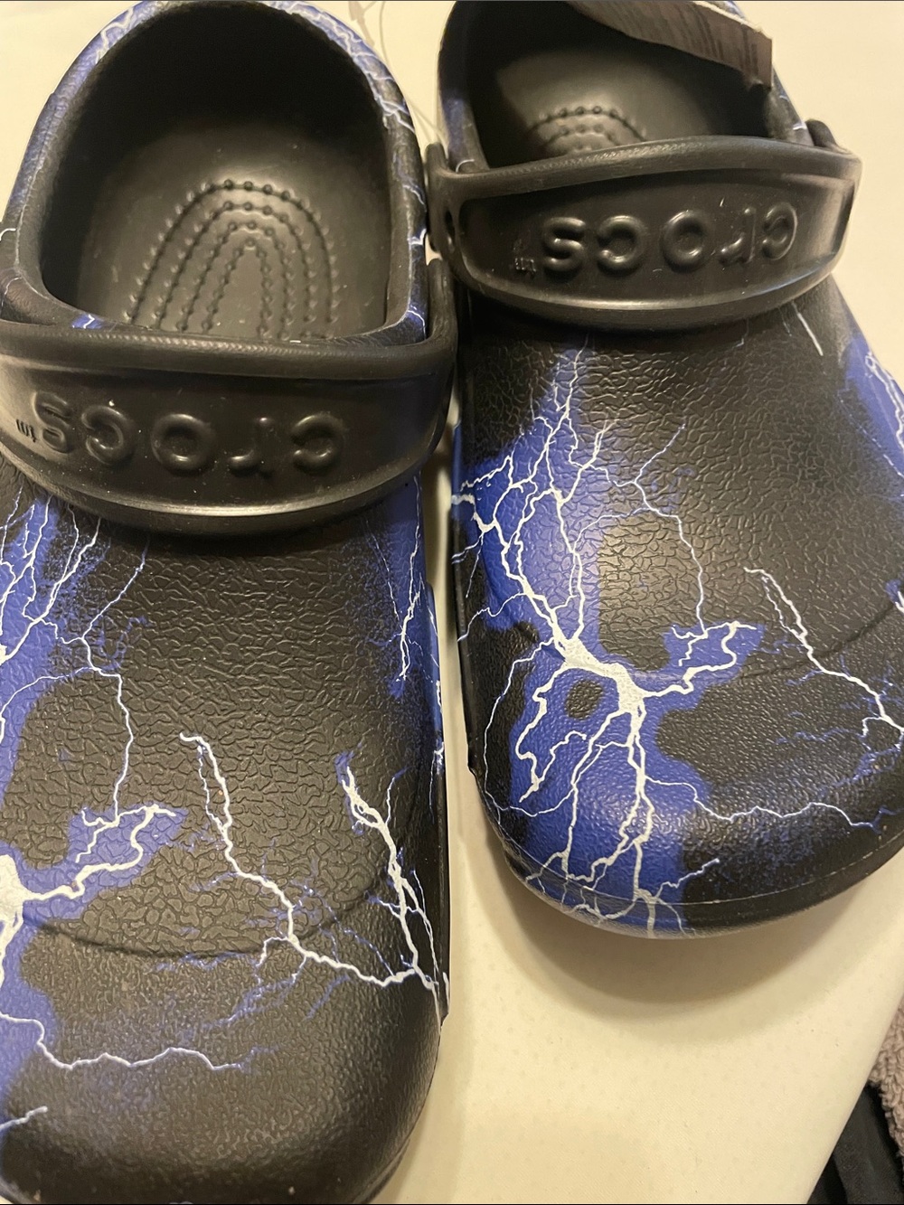 CROCS Black with Blue and White Lightning Design not sure kids - see size.